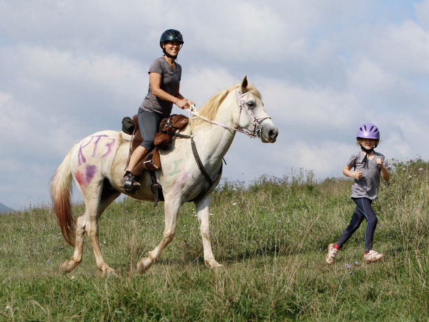 Image of a runner and a rider on a horse.